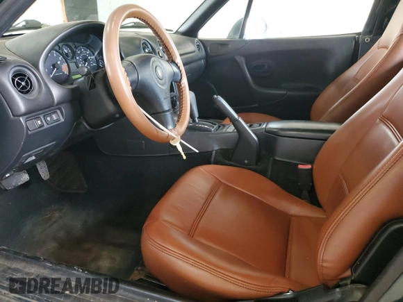 1999 Mazda MX-5 Miata z VIN JM1NB353XX0111850, wystawiony jako Copart lot #53076805 z przebiegiem 128 707 mil mil oraz Szkoda całkowita • Salvage title. Historia ofert i sprzedaży dostępna na DreamBid. Obrazek 7.