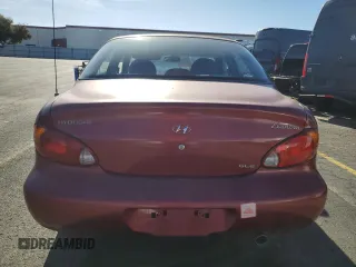 2000 Hyundai Elantra GLS z VIN KMHJF35F9YU919481, wystawiony jako Copart lot #79717924 z przebiegiem 137 918 mil mil oraz Szkoda całkowita • Salvage title. Historia ofert i sprzedaży dostępna na DreamBid. Obrazek 6.