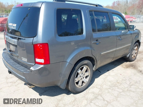 2011 Honda Pilot Touring with VIN 5FNYF4H94BB035415, listed as a IAAI auction lot 42126738 with 239,273 mi miles. Bid and sale history available at carsss.com. Image 4.