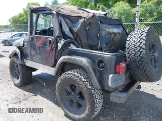 2003 Jeep Wrangler Sport z VIN 1J4FA49S53P317779, wystawiony jako IAAI lot #42388780 z przebiegiem Nie podano mil oraz . Historia ofert i sprzedaży dostępna na DreamBid. Obrazek 3.