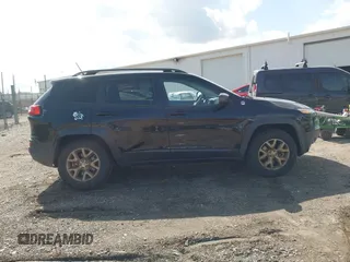 2014 Jeep Cherokee Trailhawk with VIN 1C4PJMBS6EW100500, listed as a IAAI auction lot 41894989 with 131,034 mi miles. Bid and sale history available at carsss.com. Image 13.