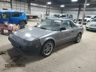 1989 Toyota MR2 z VIN JT2AW15C1K0150268, wystawiony jako Copart lot #86257134 z przebiegiem 93 969 mil mil oraz Tytuł czysty. Historia ofert i sprzedaży dostępna na DreamBid. Obrazek 1.