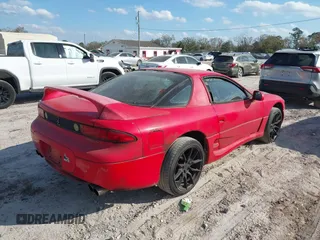 1999 Mitsubishi 3000GT z VIN JA3AM44H1XY003323, wystawiony jako IAAI lot #41560169 z przebiegiem 154 597 mil mil oraz . Historia ofert i sprzedaży dostępna na DreamBid. Obrazek 4.