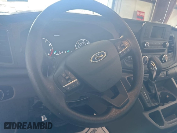 2023 Ford Transit Cargo with VIN 1FTBR1X86PKC09421, listed as a IAAI auction lot 42843981 with 10,233 mi miles and . Bid and sale history available at DreamBid. Image 10.