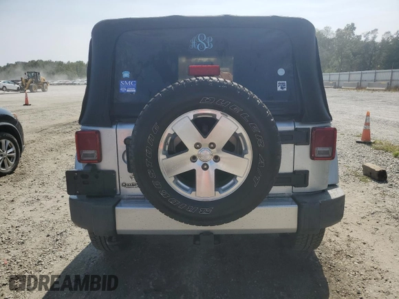 2009 Jeep Wrangler Sahara with VIN 1J4FA54119L747068, listed as a Copart auction lot 71209904 with 86,978 mi miles and Salvage title. Bid and sale history available at DreamBid. Image 6.