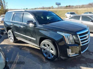 2015 Cadillac Escalade Premium z VIN 1GYS4CKJ0FR180180, wystawiony jako IAAI lot #41054933 z przebiegiem 146 974 mil mil oraz . Historia ofert i sprzedaży dostępna na DreamBid. Obrazek 1.