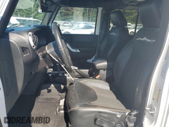 2015 Jeep Wrangler Unlimited Sahara with VIN 1C4BJWEG3FL584920, listed as a Copart auction lot 61843525 with 62,876 mi miles and Salvage title. Bid and sale history available at DreamBid. Image 7.