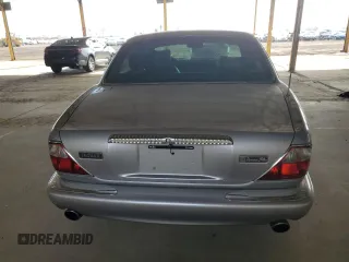 2000 Jaguar XJ with VIN SAJDA25B8YMF04079, listed as a Copart auction lot 50592595 with 131,647 mi miles and Salvage title. Bid and sale history available at DreamBid. Image 6.
