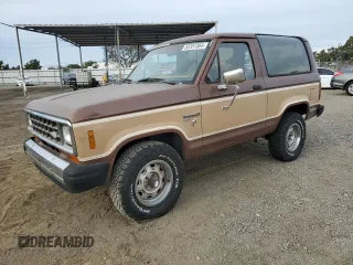 1984 Ford Bronco with VIN 1FMCU14S9EUC27301, listed as a Copart auction lot 82357364 with 657,523 mi miles and Salvage title. Bid and sale history available at DreamBid. Image 1.