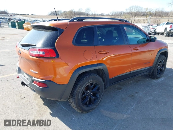 2016 Jeep Cherokee Trailhawk with VIN 1C4PJMBBXGW251682, listed as a IAAI auction lot 41973696 with 100,411 mi miles. Bid and sale history available at carsss.com. Image 4.