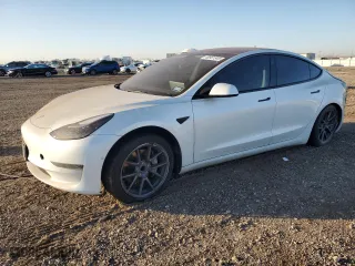2021 Tesla Model 3 Standard Range Plus with VIN 5YJ3E1EA9MF100403, listed as a Copart auction lot 48561545 with 68,996 mi miles and Salvage Title. Bid and sale history available at carsss.com. Image 1.
