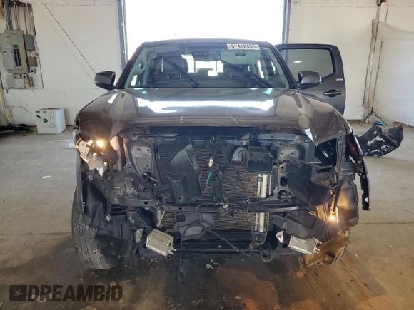 2023 Toyota Tacoma SR z VIN 3TMCZ5AN4PM599664, wystawiony jako Copart lot #57462455 z przebiegiem 65 736 mil mil oraz Szkoda całkowita • Salvage title. Historia ofert i sprzedaży dostępna na DreamBid. Obrazek 5.
