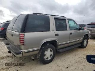 1999 GMC Yukon with VIN 1GKEK13R5XJ767903, listed as a Copart auction lot 84158844 with 112,229 mi miles and Salvage Title. Bid and sale history available at carsss.com. Image 3.