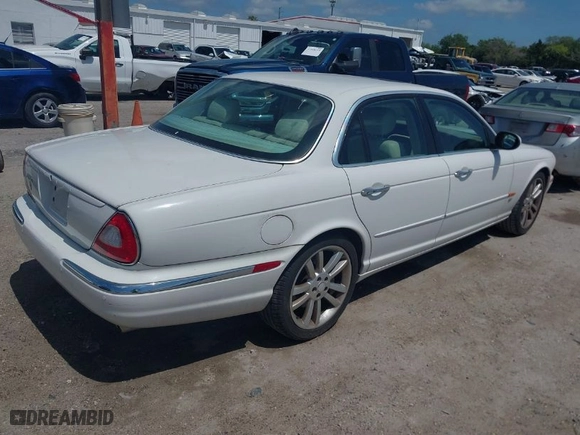 2004 Jaguar XJ with VIN SAJWA73BX4TG14270, listed as a IAAI auction lot 41905325 with 104908 miles. Bid and sale history available at carsss.com. Image 4.
