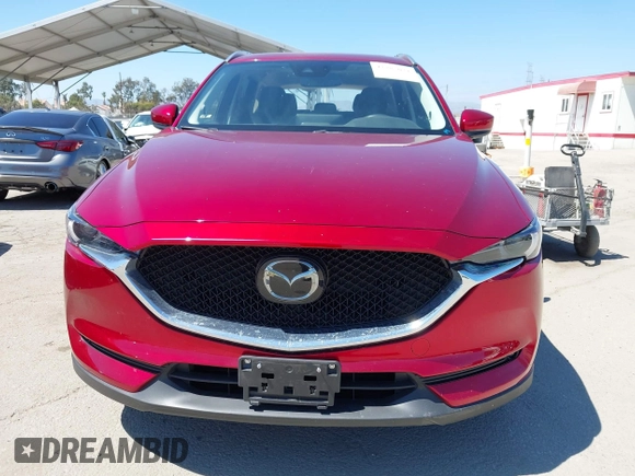 2021 Mazda CX-5 Grand Touring with VIN JM3KFADM5M0470483, listed as a IAAI auction lot 42785031 with 30,749 mi miles and . Bid and sale history available at DreamBid. Image 12.