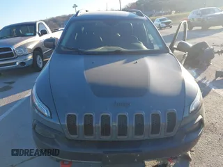 2015 Jeep Cherokee Trailhawk with VIN 1C4PJMBSXFW614416, listed as a IAAI auction lot 41033241 with 112,015 mi miles. Bid and sale history available at carsss.com. Image 13.