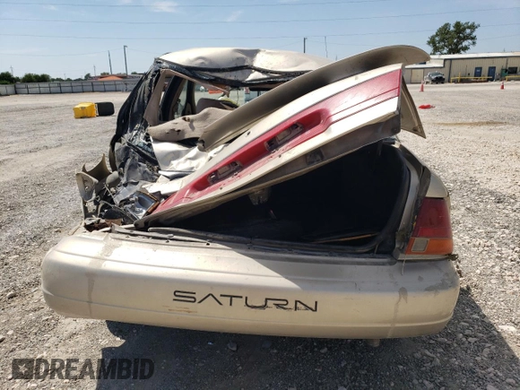 1998 Saturn SL z VIN 1G8ZK5271WZ265579, wystawiony jako Copart lot #68153934 z przebiegiem Nie podano mil oraz Szkoda całkowita • Salvage title. Historia ofert i sprzedaży dostępna na DreamBid. Obrazek 6.