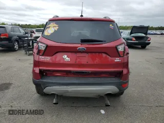 2018 Ford Escape SE z VIN 1FMCU9GD7JUB01668, wystawiony jako Copart lot #57038675 z przebiegiem 70 780 mil mil oraz Szkoda całkowita • Salvage title. Historia ofert i sprzedaży dostępna na DreamBid. Obrazek 6.