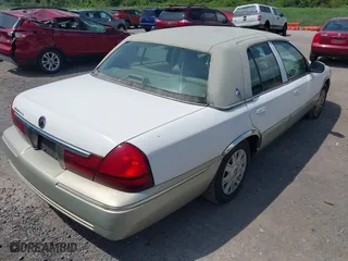 2004 Mercury Grand Marquis GS with VIN 2MEFM74W44X673224, listed as a IAAI auction lot 40670734 with 83,219 mi miles. Bid and sale history available at carsss.com. Image 4.