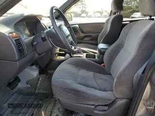 1999 Jeep Grand Cherokee Laredo with VIN 1J4GW58N4XC739465, listed as a Copart auction lot 76130544 with 195,649 mi miles and Salvage title. Bid and sale history available at DreamBid. Image 7.