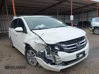 2014 Honda Odyssey Touring with VIN 5FNRL5H95EB059729, listed as a IAAI auction lot 42148110 with 135,304 mi miles and . Bid and sale history available at DreamBid. Image 1.