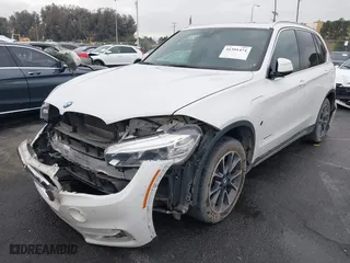 2018 BMW X5 xDrive40e iPerformance with VIN 5UXKT0C58J0V99415, listed as a IAAI auction lot 41391474 with 124,671 mi miles. Bid and sale history available at carsss.com. Image 2.