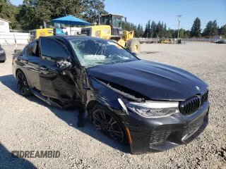 2018 BMW M5 z VIN WBSJF0C57JB283361, wystawiony jako Copart lot #65352164 z przebiegiem Nie podano mil oraz Szkoda całkowita • Salvage title. Historia ofert i sprzedaży dostępna na DreamBid. Obrazek 4.