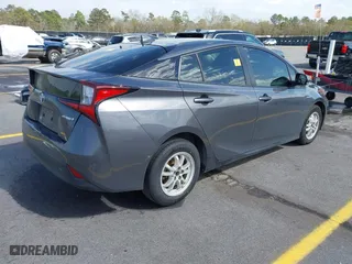 2021 Toyota Prius L Eco with VIN JTDKAMFU4M3134778, listed as a IAAI auction lot 41843429 with 145,757 mi miles. Bid and sale history available at carsss.com. Image 4.