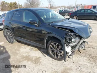 2016 Mazda CX-5 Grand Touring z VIN JM3KE4DY9G0635317, wystawiony jako IAAI lot #41829081 z przebiegiem 96 819 mil mil oraz . Historia ofert i sprzedaży dostępna na DreamBid. Obrazek 1.