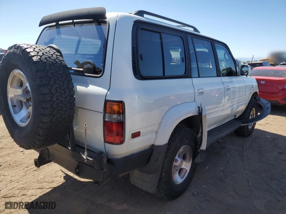 1997 Toyota Land Cruiser with VIN JT3HJ85J2V0180979, listed as a Copart auction lot 73216714 with 239,444 mi miles and Salvage Title. Bid and sale history available at carsss.com. Image 3.
