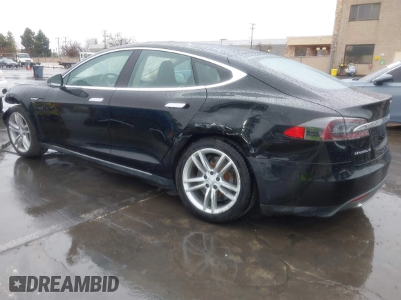 2013 Tesla Model S with VIN 5YJSA1CN0DFP20053, listed as a IAAI auction lot 41470660 with 61,568 mi miles and . Bid and sale history available at DreamBid. Image 3.