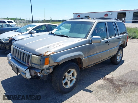 1998 Jeep Grand Cherokee Limited z VIN 1J4GZ88Z4WC328450, wystawiony jako IAAI lot #42652126 z przebiegiem 166 576 mil mil oraz . Historia ofert i sprzedaży dostępna na DreamBid. Obrazek 2.