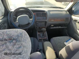 2001 Suzuki Vitara JLS z VIN 2S3TC52C116101163, wystawiony jako Copart lot #74469744 z przebiegiem Nie podano mil oraz Szkody całkowita. Historia ofert i sprzedaży dostępna na DreamBid. Obrazek 8.