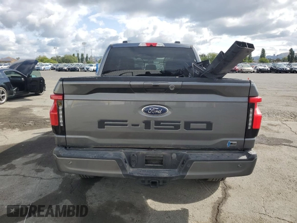 2023 Ford F-150 Lightning Pro with VIN 1FT6W1EV0PWG34788, listed as a Copart auction lot 54454805 with 11,432 mi miles and Salvage title. Bid and sale history available at DreamBid. Image 6.