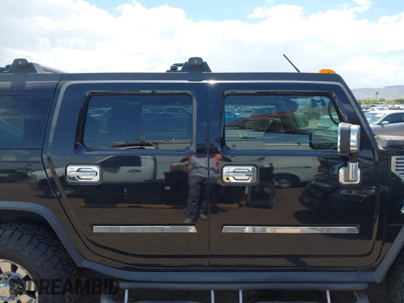 2003 Hummer H2 with VIN 5GRGN23U73H122756, listed as a IAAI auction lot 42194176 with 239,411 mi miles. Bid and sale history available at carsss.com. Image 13.