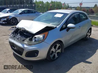 2014 Kia Rio SX with VIN KNADN5A31E6353714, listed as a IAAI auction lot 42127657 with 117,544 mi miles. Bid and sale history available at carsss.com. Image 2.