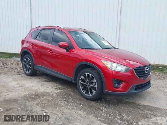 2016 Mazda CX-5 Grand Touring z VIN JM3KE2DY6G0693678, wystawiony jako IAAI lot #42443247 z przebiegiem 127 620 mil mil oraz . Historia ofert i sprzedaży dostępna na DreamBid. Obrazek 1.