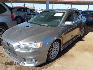 2014 Mitsubishi Lancer Evolution GSR with VIN JA32W8FV3EU008262, listed as a IAAI auction lot 41653902 with 128,977 mi miles. Bid and sale history available at carsss.com. Image 2.