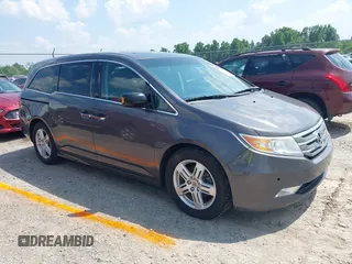 2013 Honda Odyssey Touring with VIN 5FNRL5H98DB077916, listed as a IAAI auction lot 42415057 with 256,463 mi miles and . Bid and sale history available at DreamBid. Image 1.