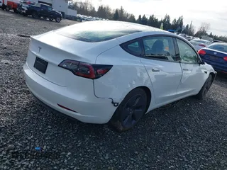 2021 Tesla Model 3 Standard Range Plus z VIN 5YJ3E1EAXMF871730, wystawiony jako IAAI lot #41794274 z przebiegiem 18 791 mil mil oraz . Historia ofert i sprzedaży dostępna na DreamBid. Obrazek 4.