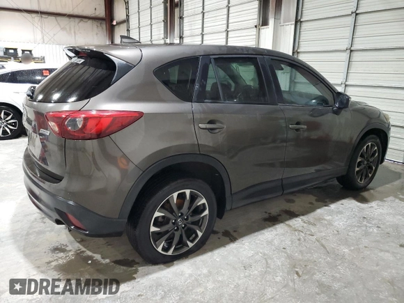 2016 Mazda CX-5 Grand Touring z VIN JM3KE2DY5G0821683, wystawiony jako Copart lot #51929905 z przebiegiem 119 392 mil mil oraz Czysty tytuł • Clean title. Historia ofert i sprzedaży dostępna na DreamBid. Obrazek 3.