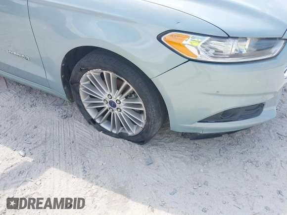 2013 Ford Fusion SE Hybrid z VIN 3FA6P0LU8DR265460, wystawiony jako IAAI lot #42720385 z przebiegiem 146 179 mil mil oraz . Historia ofert i sprzedaży dostępna na DreamBid. Obrazek 6.