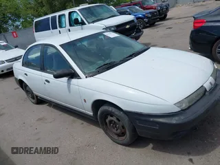1996 Saturn SL z VIN 1G8ZH5287TZ196724, wystawiony jako IAAI lot #42394672 z przebiegiem 223 179 mil mil oraz . Historia ofert i sprzedaży dostępna na DreamBid. Obrazek 1.