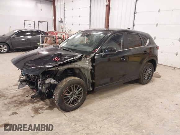 2021 Mazda CX-5 Touring with VIN JM3KFBCM1M1380409, listed as a IAAI auction lot 41677537 with 55,319 mi miles. Bid and sale history available at carsss.com. Image 2.