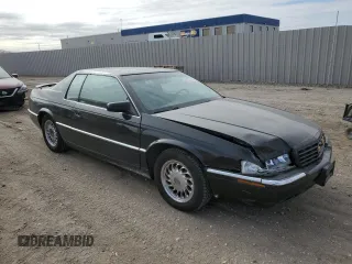 1999 Cadillac Eldorado Touring z VIN 1G6ET1298XU602343, wystawiony jako Copart lot #44327195 z przebiegiem 52 327 mil mil oraz Szkody całkowita. Historia ofert i sprzedaży dostępna na DreamBid. Obrazek 4.