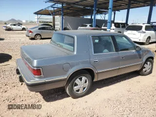 1991 Dodge Dynasty LE z VIN 1B3XC56R9MD115785, wystawiony jako Copart lot #48073715 z przebiegiem 64 483 mil mil oraz Szkoda całkowita • Salvage title. Historia ofert i sprzedaży dostępna na DreamBid. Obrazek 3.