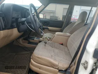 2000 Jeep Cherokee with VIN 1J4FF48S1YL174377, listed as a Copart auction lot 50032345 with 204,234 mi miles and Salvage title. Bid and sale history available at DreamBid. Image 7.