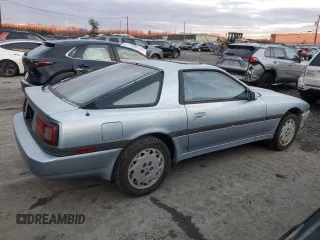 1986 Toyota Supra z VIN JT2MA70L4G0016772, wystawiony jako Copart lot #85806484 z przebiegiem 128 504 mil mil oraz Czysty tytuł • Clean title. Historia ofert i sprzedaży dostępna na DreamBid. Obrazek 3.