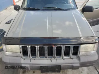 1996 Jeep Grand Cherokee Laredo with VIN 1J4GZ58S3TC245928, listed as a Copart auction lot 57313735 with 165,733 mi miles and Salvage title. Bid and sale history available at DreamBid. Image 12.