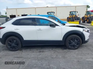 2024 Mazda CX-30 Premium z VIN 3MVDMBDY7RM706554, wystawiony jako IAAI lot #42322863 z przebiegiem 2817 mil mil oraz . Historia ofert i sprzedaży dostępna na DreamBid. Obrazek 13.